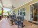 Inviting covered deck with rocking chairs, ceiling fans, and an outdoor dining area perfect for entertaining at 612 Ideal Way, Charlotte, NC 28203