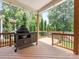 Covered deck featuring a cooking grill with a natural wooded view, perfect for outdoor entertaining at 612 Ideal Way, Charlotte, NC 28203