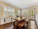 The dining area is filled with natural light, featuring hardwood floors, built-in cabinetry, and access to the porch at 612 Ideal Way, Charlotte, NC 28203