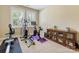 Bright exercise room featuring an elliptical machine, stationary bike, and storage cabinet with books at 612 Ideal Way, Charlotte, NC 28203