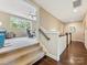 Upstairs hallway featuring hardwood floors and a carpeted staircase leading to an upstairs recreational area at 612 Ideal Way, Charlotte, NC 28203