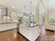 Bright, open kitchen with white cabinetry, stainless steel appliances, and an island with seating at 612 Ideal Way, Charlotte, NC 28203