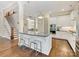 Modern kitchen island with seating, white cabinets, and hardwood floors, perfect for entertaining at 612 Ideal Way, Charlotte, NC 28203