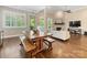 Open-concept living area, seamlessly connecting to the dining room, showcases hardwood floors, fireplace, and ample natural light at 612 Ideal Way, Charlotte, NC 28203