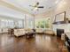 Spacious living room with a fireplace, hardwood floors, and large windows, creating a cozy and inviting atmosphere at 612 Ideal Way, Charlotte, NC 28203