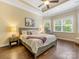 Comfortable main bedroom featuring hardwood floors, a tray ceiling, a sitting area, and great natural light at 612 Ideal Way, Charlotte, NC 28203