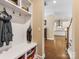 Convenient mud room with coat hooks, storage bench, and easy access to the kitchen and hallway at 612 Ideal Way, Charlotte, NC 28203