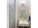 Well-lit powder room with a modern vanity, sleek mirror, and neutral tones, creating a minimalist design at 612 Ideal Way, Charlotte, NC 28203