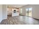 Open-concept living area with hardwood floors, a kitchen island, and sliding glass doors at 6331 Fairfax Ct, Maiden, NC 28650