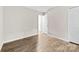 Bedroom with laminate flooring, neutral paint, closet and open doorway at 6340 Green Vista Ct, Charlotte, NC 28212