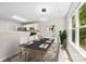 Dining area has a modern light fixture, connects to the kitchen, and has a large window for natural light at 6340 Green Vista Ct, Charlotte, NC 28212