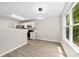 A dining area connects to a neutral kitchen, with a large window offering natural light at 6340 Green Vista Ct, Charlotte, NC 28212