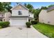 Charming two-story home with a white exterior, attached garage, and well-manicured landscaping at 6340 Green Vista Ct, Charlotte, NC 28212