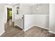 Cozy hallway space with durable wood flooring and neutral paint enhances the home's appeal at 6340 Green Vista Ct, Charlotte, NC 28212