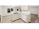 Bright kitchen features a stainless steel sink, white cabinets, and modern countertops at 6340 Green Vista Ct, Charlotte, NC 28212