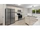 Bright kitchen with stainless steel appliances, light cabinets, and marble countertops at 6340 Green Vista Ct, Charlotte, NC 28212