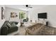Cozy living room with a ceiling fan, large windows, and neutral decor for relaxation at 6340 Green Vista Ct, Charlotte, NC 28212
