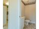 Powder bathroom with tile floor, white cabinet and toilet at 639 Panther Point Trl, Richfield, NC 28137