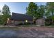 Exterior features include a shed, gravel driveway, and charming facade, adding character to the home at 639 Panther Point Trl, Richfield, NC 28137