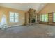 Inviting living room features a stone fireplace, built-in bookcases, and lots of natural light at 639 Panther Point Trl, Richfield, NC 28137
