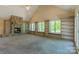 Spacious living room with a stone fireplace, built-in bookcases, and an abundance of natural light at 639 Panther Point Trl, Richfield, NC 28137