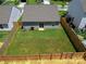 An aerial view of the backyard, showing a fenced yard with green grass at 672 Lamorak Pl, Richburg, SC 29729