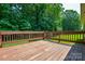 Outdoor deck provides views of the green yard, with wooden railings at 676 Rebecca Jane Dr, Mooresville, NC 28115