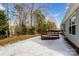 A snow covered backyard with a deck and beautiful trees at 676 Rebecca Jane Dr, Mooresville, NC 28115