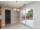Open dining room with sliding glass doors to the deck and stylish chandelier at 676 Rebecca Jane Dr, Mooresville, NC 28115