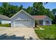 Charming single-story home featuring an attached garage, manicured lawn, and inviting curb appeal at 676 Rebecca Jane Dr, Mooresville, NC 28115