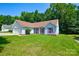 Inviting single-story home with a well-maintained lawn, red shutters, and lush surrounding trees at 676 Rebecca Jane Dr, Mooresville, NC 28115