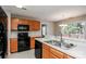 Efficient kitchen with black appliances, a double sink and access to the back deck at 676 Rebecca Jane Dr, Mooresville, NC 28115
