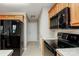 Practical kitchen featuring black appliances, ample cabinet space, and neutral countertops at 676 Rebecca Jane Dr, Mooresville, NC 28115
