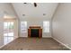 Inviting living room featuring a cozy fireplace, carpeted floors and ample natural light at 676 Rebecca Jane Dr, Mooresville, NC 28115