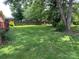 Fenced backyard featuring green lawn and mature trees at 715 Sunridge Dr, Lincolnton, NC 28092