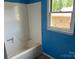 Basic bathtub with bright blue walls at 715 Sunridge Dr, Lincolnton, NC 28092