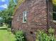 Exterior side view showing brick facade, windows, and well maintained lawn at 715 Sunridge Dr, Lincolnton, NC 28092
