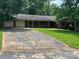 Charming one-story brick home with a long driveway and mature trees at 715 Sunridge Dr, Lincolnton, NC 28092