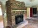 Open living room featuring a brick fireplace, offering a cozy focal point at 715 Sunridge Dr, Lincolnton, NC 28092
