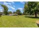 Large backyard with mature trees and green grass, perfect for outdoor activities and enjoyment at 7430 Forney Hill Rd, Denver, NC 28037