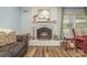 Close-up of a white brick fireplace with a decorative mantel, adding charm to the living space at 7430 Forney Hill Rd, Denver, NC 28037