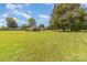 Wide shot of the home's expansive yard, featuring mature trees and a well-manicured lawn at 7430 Forney Hill Rd, Denver, NC 28037