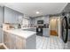 The kitchen has gray cabinets, white tile floor, and modern appliances at 7430 Forney Hill Rd, Denver, NC 28037
