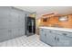 A well-lit kitchen with gray cabinets, a refrigerator, and an eat-in dining area at 7430 Forney Hill Rd, Denver, NC 28037