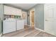 Laundry room with appliances, lots of storage, and access to a half bath at 7430 Forney Hill Rd, Denver, NC 28037