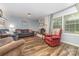 Cozy living room featuring hardwood floors, a brick fireplace, and comfortable seating at 7430 Forney Hill Rd, Denver, NC 28037