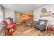 Open-concept living area with wood floors, comfortable seating, and view into the dining space at 7430 Forney Hill Rd, Denver, NC 28037