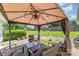 Relaxing covered patio with string lights and backyard view perfect for outdoor entertaining at 7430 Forney Hill Rd, Denver, NC 28037