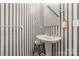 Powder room featuring wallpaper, pedestal sink, and updated fixtures at 7430 Forney Hill Rd, Denver, NC 28037