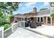 Spacious backyard featuring a deck, patio with grill, lush greenery, and inviting outdoor space at 935 Trentle Ct, Charlotte, NC 28211